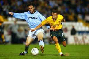 Eduardo Berizzo of Celta Vigo attempts to shield the ball from Henrik Larsson of Celtic