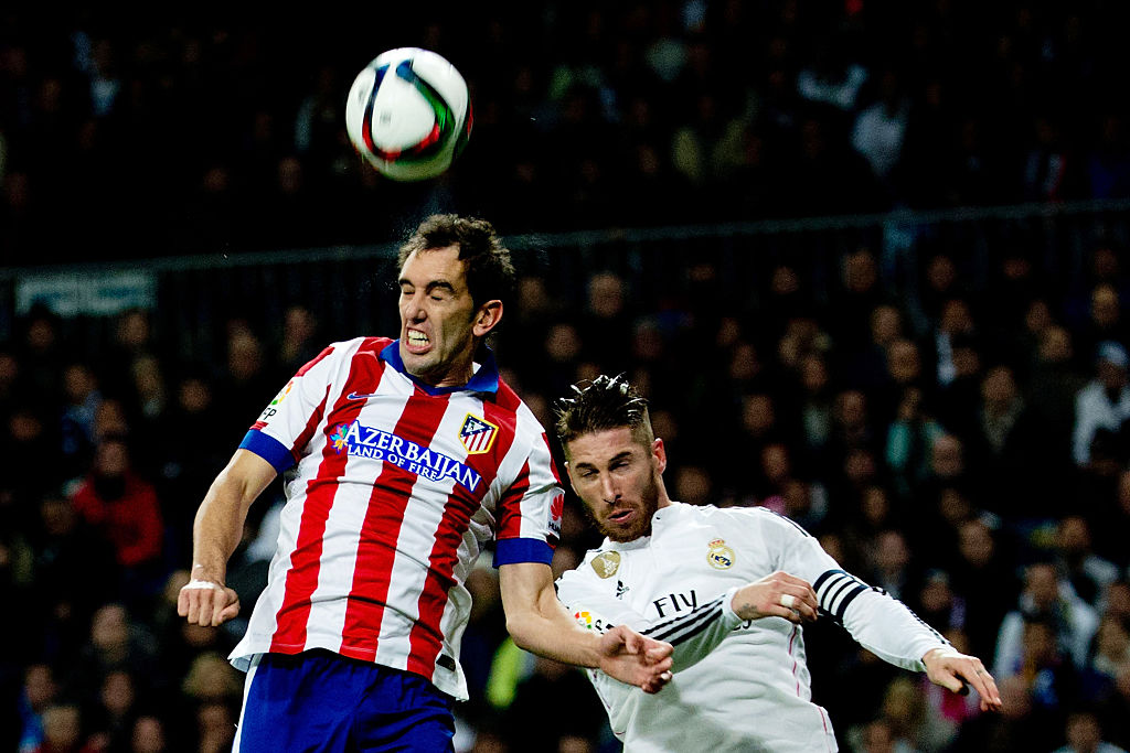 MADRID, SPAIN - JANUARY 15: Diego Godin of Atletico de Madrid wins the header after Sergio Ramos of Real Madrid CF during the Copa del Rey Round of 16 second leg match between Real Madrid CF and Club Atletico de Madrid at Estadio Santiago Bernabeu on January 15, 2015 in Madrid, Spain. (Photo by Gonzalo Arroyo Moreno/Getty Images)