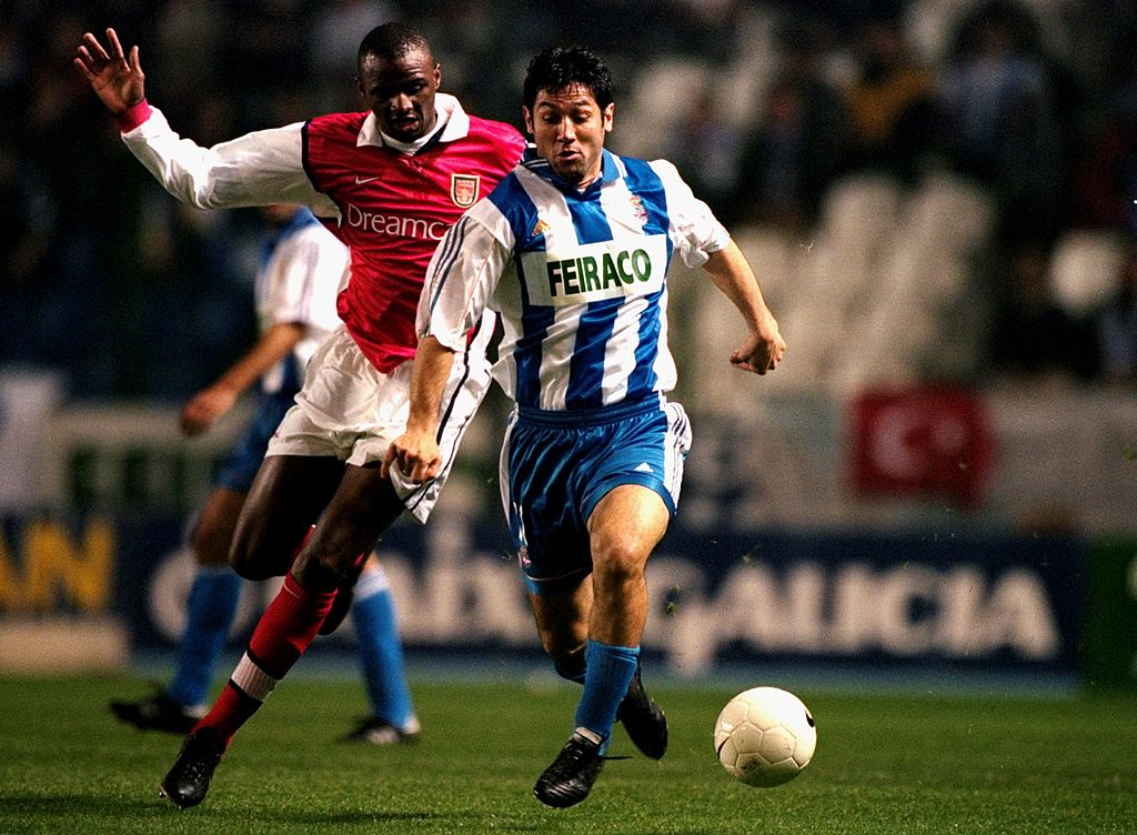 Turu Flores of Deportivo La Coruna is chased by Patrick Vieira of Arsenal